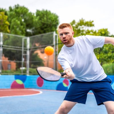 energetic-man-playing-pickelball-in-a-colorful-out-2024-12-10-03-08-42-utc-min-min